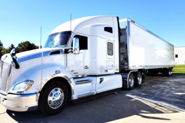 A white truck is parked on the side of the road.