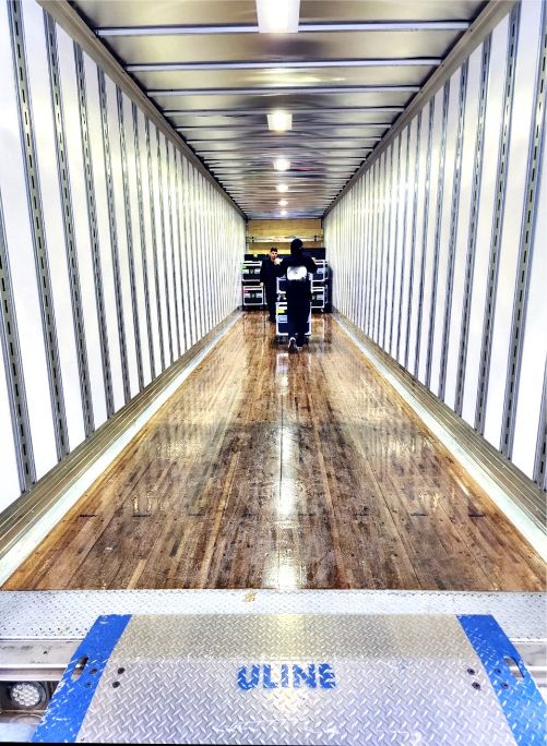 A long hallway with many people walking on it